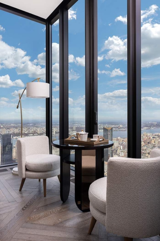 dining room featuring a water view, a view of city, and floor to ceiling windows