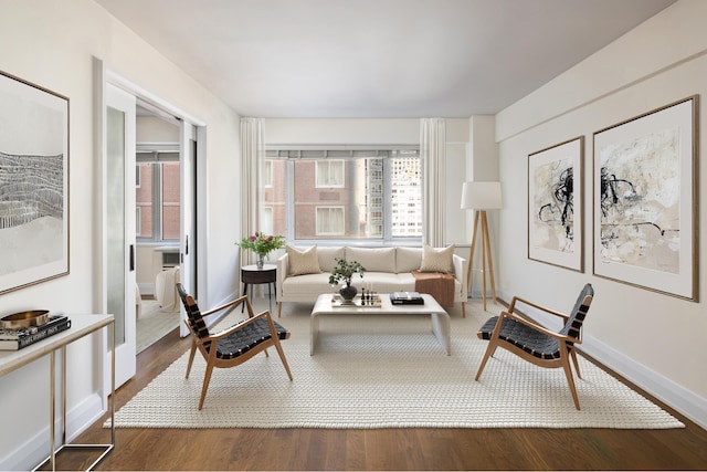 living area with wood finished floors and baseboards
