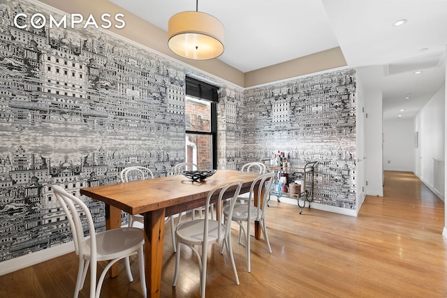 dining space with wood finished floors and baseboards