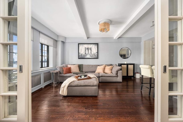 living room with beamed ceiling and wood finished floors