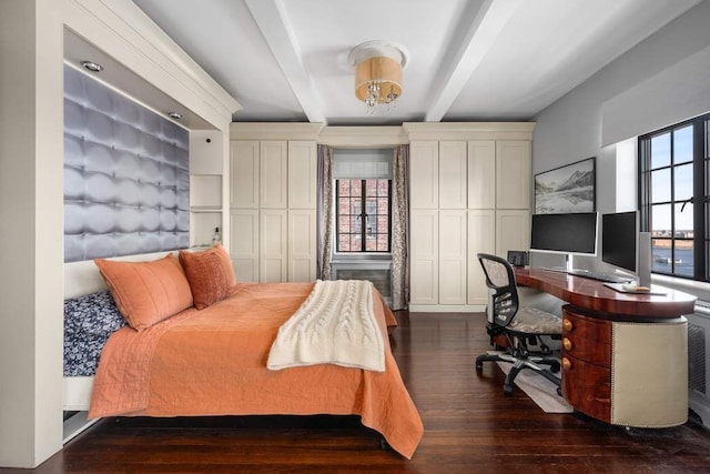 bedroom with beam ceiling and dark wood-style flooring