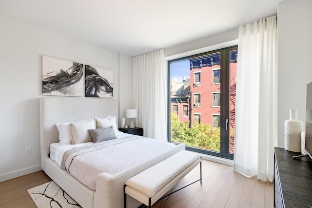 bedroom featuring baseboards and light wood-style floors