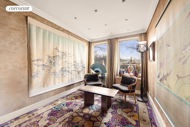 living area with baseboards and ornamental molding