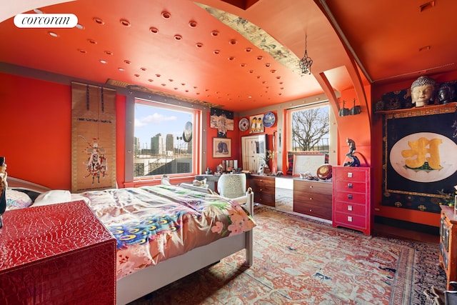 bedroom with visible vents and a city view