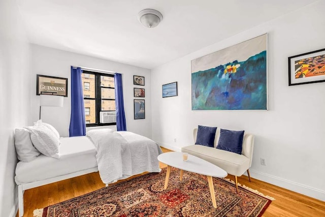 bedroom with wood finished floors and baseboards