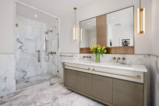 full bathroom with double vanity, marble finish floor, a marble finish shower, and a sink