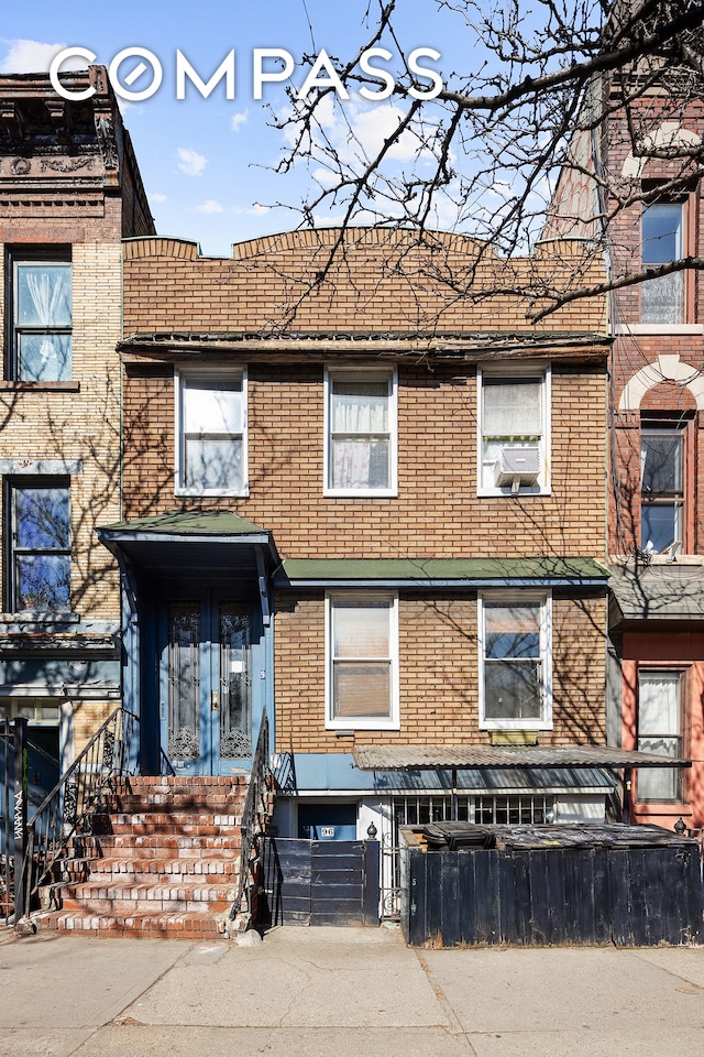 townhome / multi-family property with brick siding