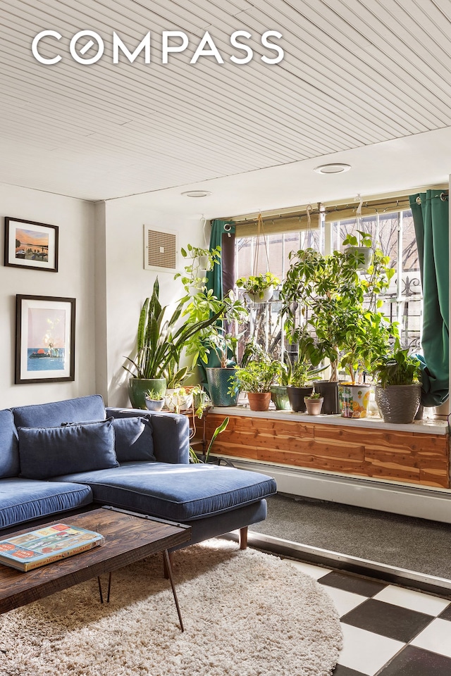 sunroom featuring wooden ceiling and visible vents