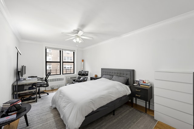 bedroom with ceiling fan, radiator, wood finished floors, and ornamental molding