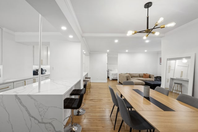 dining room with baseboards, recessed lighting, ornamental molding, light wood-type flooring, and a chandelier