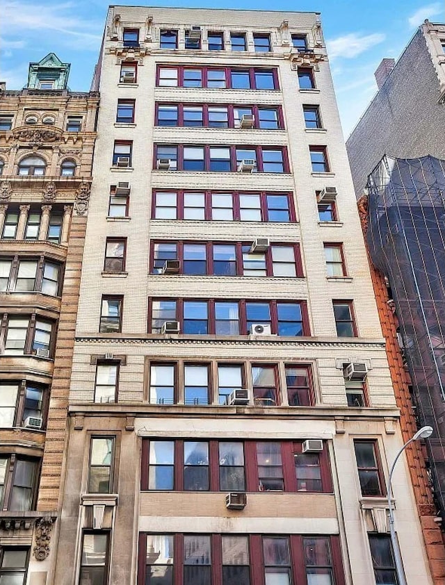 view of building exterior featuring a wall unit AC