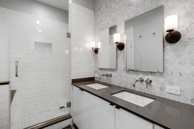 full bathroom with backsplash, a shower stall, and a sink