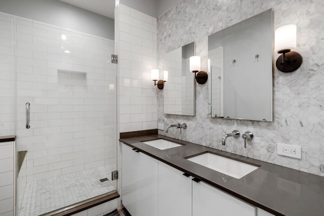 full bathroom with decorative backsplash, a shower stall, and a sink