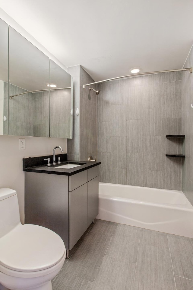 bathroom featuring toilet, vanity, and  shower combination