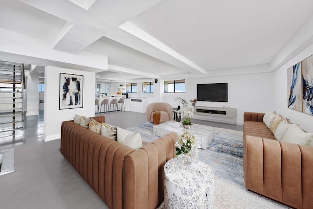 living room featuring stairway and baseboards