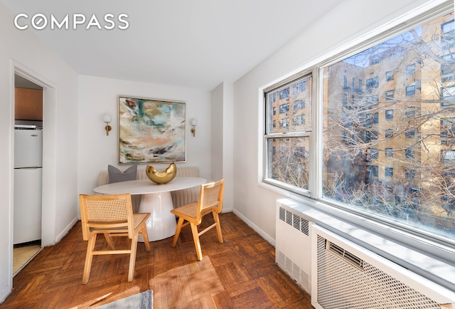 dining room featuring radiator and baseboards