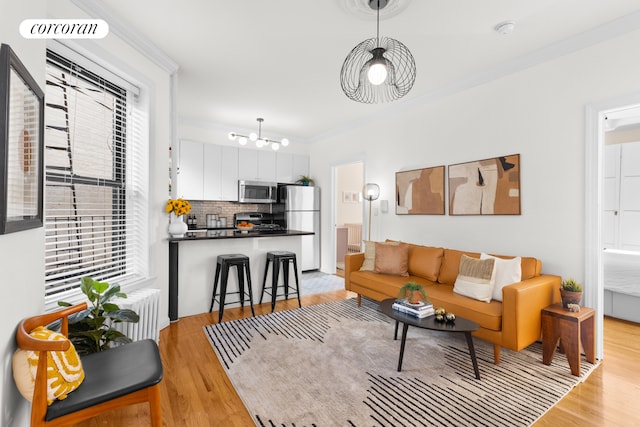 382 Prospect Pl Unit 15, New York City, NY 11238 - living room with light wood-style flooring, ornamental molding, and a chandelier
