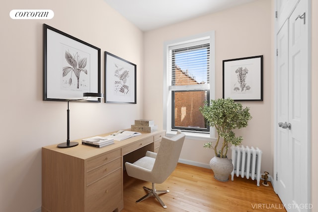 382 Prospect Pl Unit 15, New York City, NY 11238 - office area featuring radiator heating unit, light wood-type flooring, and baseboards
