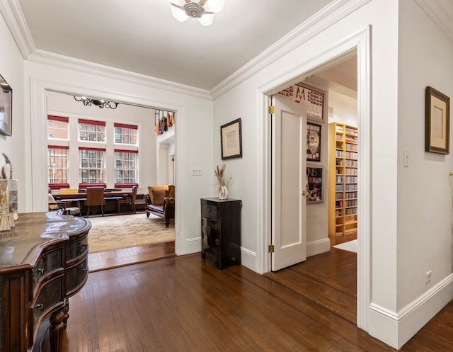 interior space with hardwood / wood-style floors, baseboards, and ornamental molding