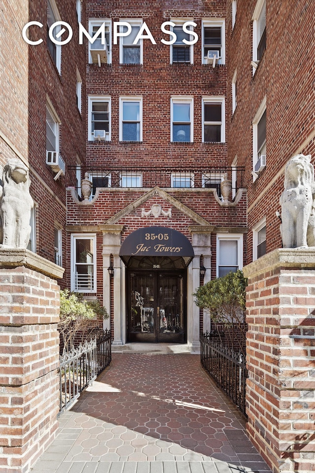 doorway to property featuring brick siding