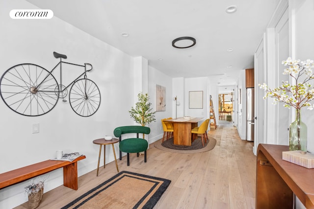 hallway featuring baseboards, recessed lighting, light wood-style flooring, and visible vents