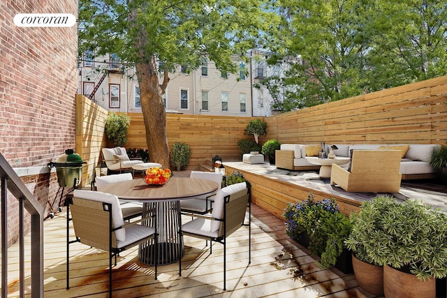 1198 Jefferson Ave Unit A, New York City, NY 11221 - deck with outdoor dining area, a fenced backyard, and an outdoor hangout area