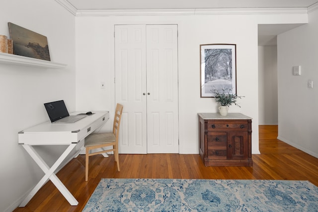 office area featuring baseboards, wood finished floors, and crown molding