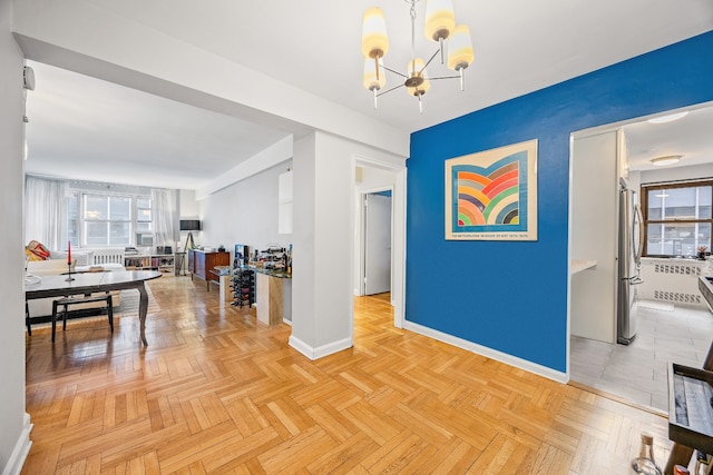 interior space featuring baseboards and a chandelier