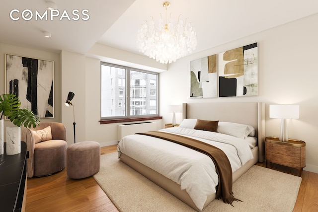 bedroom featuring an inviting chandelier, radiator heating unit, light wood-style floors, and baseboards