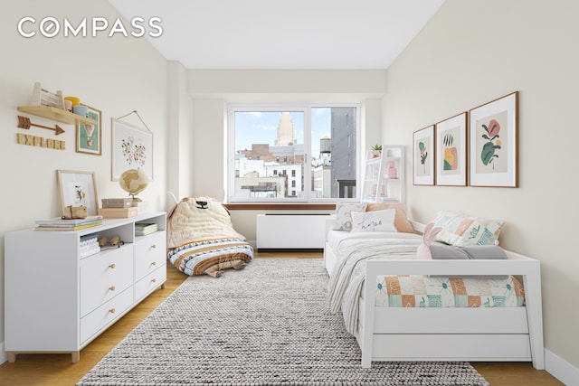 bedroom with light wood-type flooring and baseboards