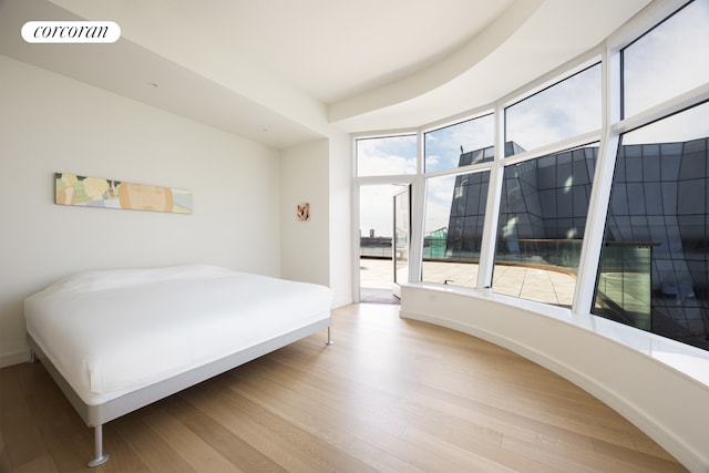 bedroom featuring wood finished floors and visible vents