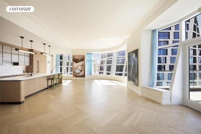 kitchen with visible vents, light countertops, tasteful backsplash, modern cabinets, and open floor plan