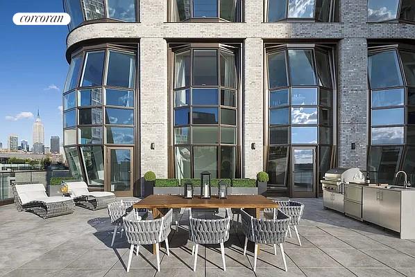 view of patio featuring a sink, grilling area, a city view, and exterior kitchen