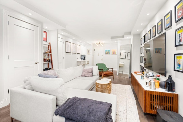 living room with recessed lighting, baseboards, and wood finished floors