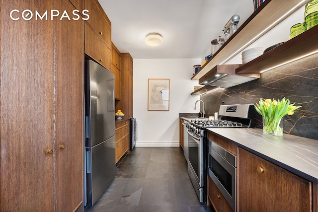 kitchen featuring open shelves, backsplash, stainless steel appliances, wall chimney exhaust hood, and brown cabinetry