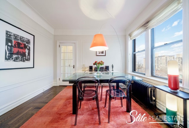 dining room featuring parquet floors and baseboards