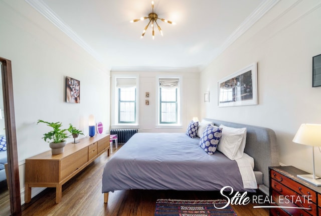 bedroom featuring crown molding, radiator, wood finished floors, and a chandelier