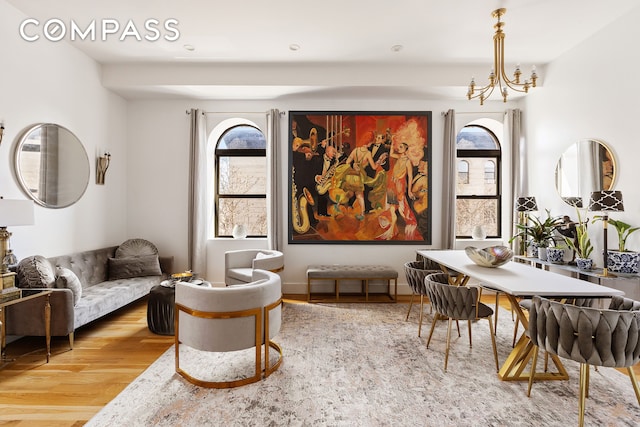 living area with a notable chandelier and wood finished floors