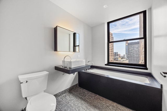 20 Pine St Unit 2907, New York City, NY 10005 - full bath featuring a sink, toilet, a garden tub, and baseboards