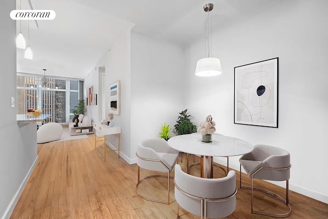 1600 Broadway Unit 16G, New York City, NY 10019 - dining room with baseboards, light wood-style floors, and a chandelier