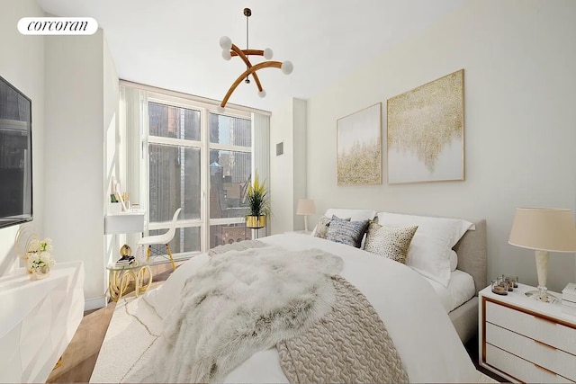 bedroom with visible vents and wood finished floors