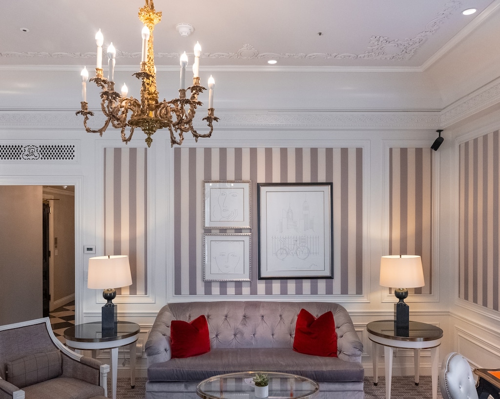 2 E 55th St Unit 931/935, New York City, NY 10022 - living area with a chandelier, a decorative wall, and ornamental molding