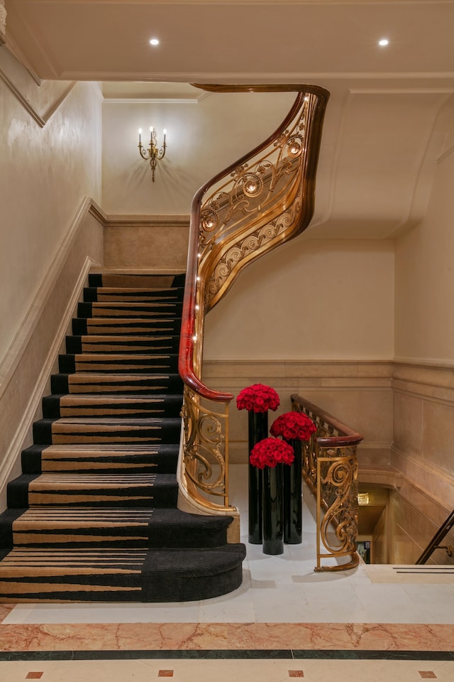 staircase with recessed lighting and wainscoting