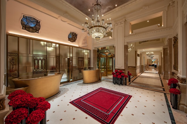 2 E 55th St Unit 931/935, New York City, NY 10022 - common area with a decorative wall, crown molding, a high ceiling, and a wainscoted wall
