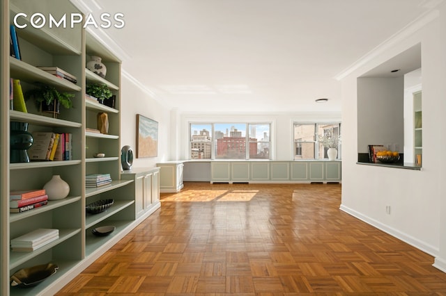 interior space with a city view, crown molding, and baseboards