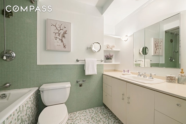 full bath featuring toilet, tile walls, and vanity