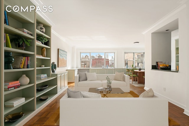 living room with baseboards, a city view, and crown molding