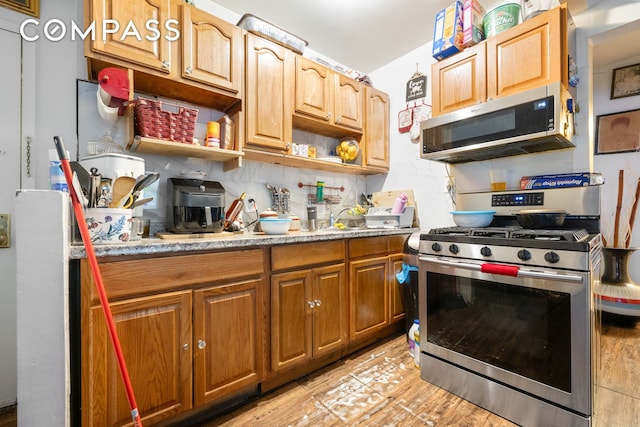 kitchen featuring open shelves, decorative backsplash, light stone countertops, and appliances with stainless steel finishes