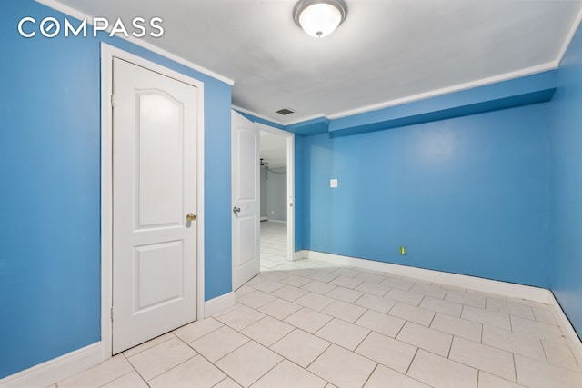 unfurnished room featuring baseboards and visible vents