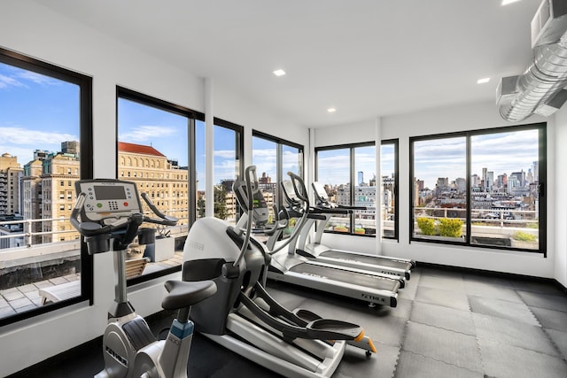 305 2nd Ave Unit 530, New York City, NY 10003 - exercise room featuring a view of skyline, plenty of natural light, and recessed lighting